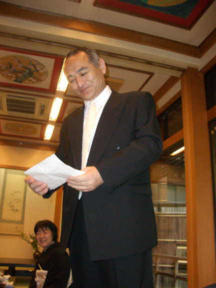 Yumi's father giving a speech...